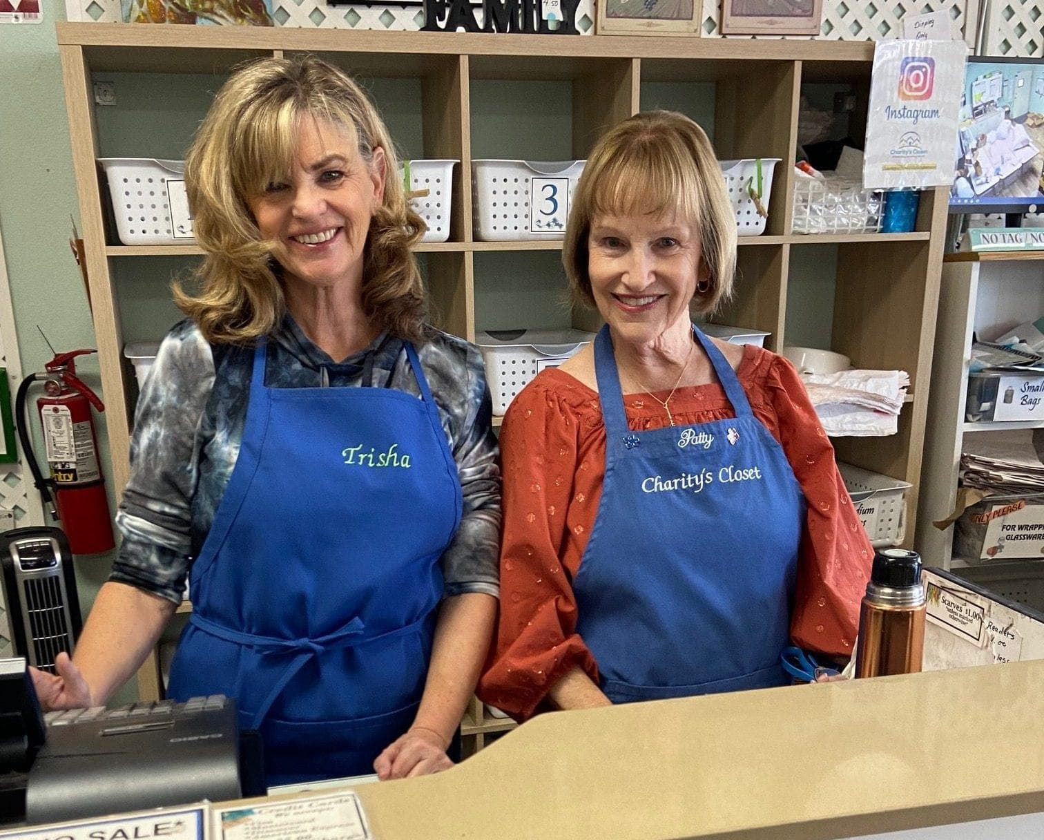 Two smiling volunteers at the register